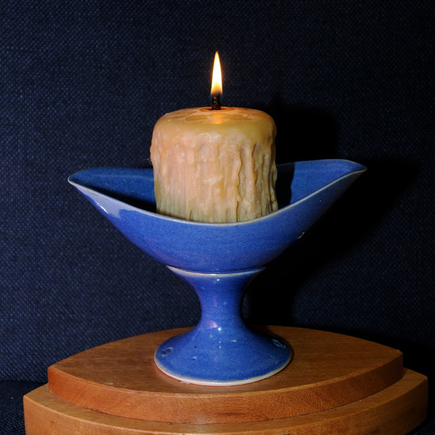 blue clay chalice with lit thick beeswax candle